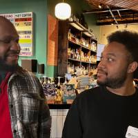 An alum and a student talk in the restaurant